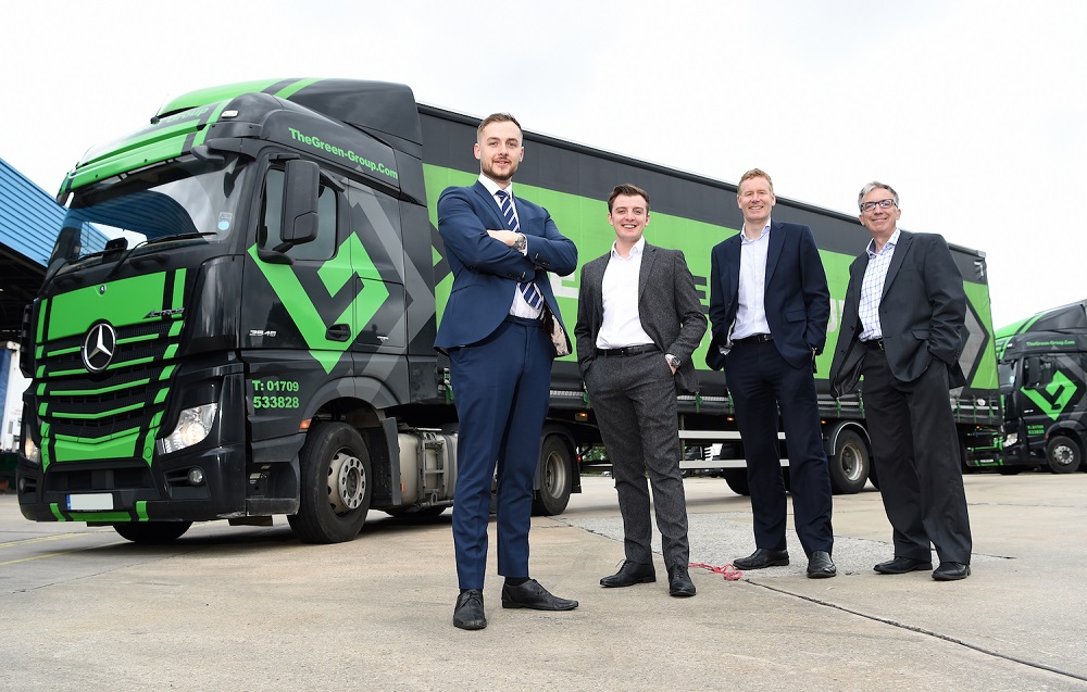 4 men in suits from Avail Technologies stood in front of a Mercedes Benz lorry